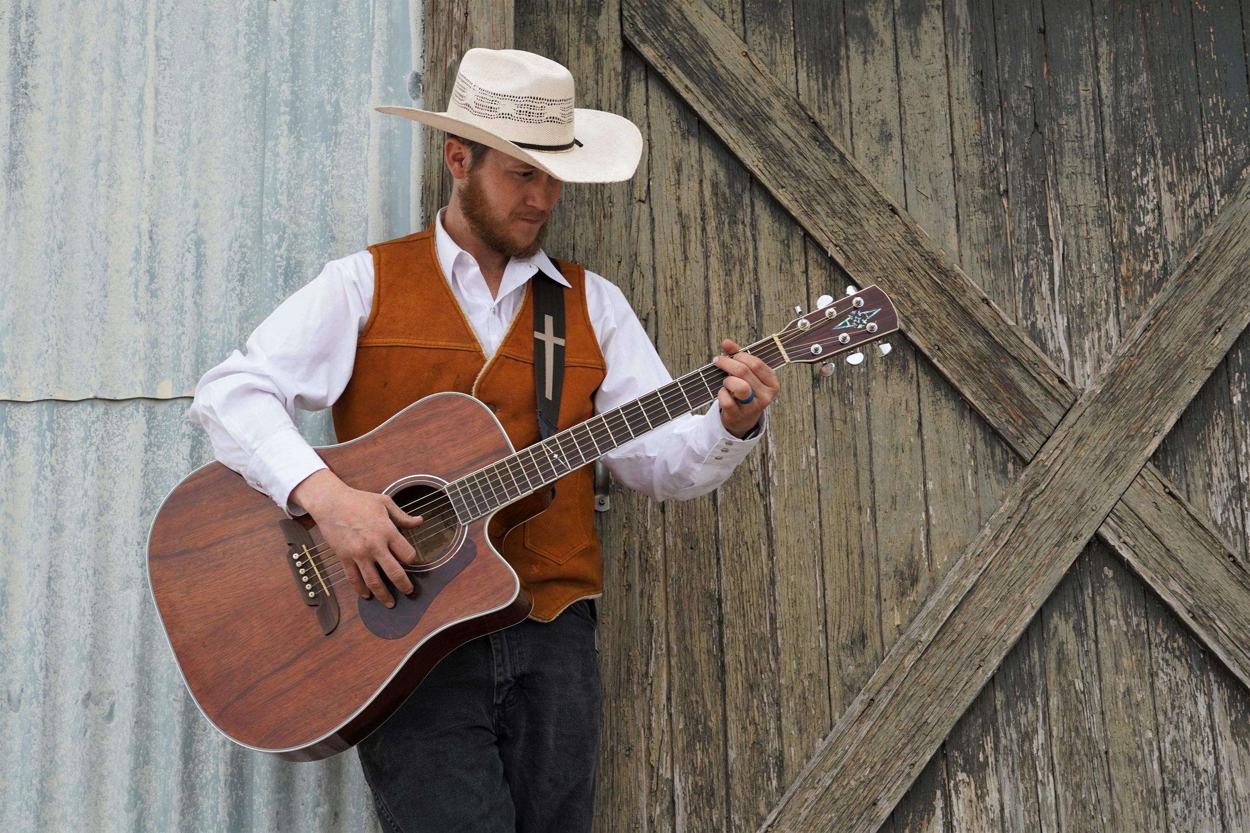 Portrait of cowboy in boots and hat