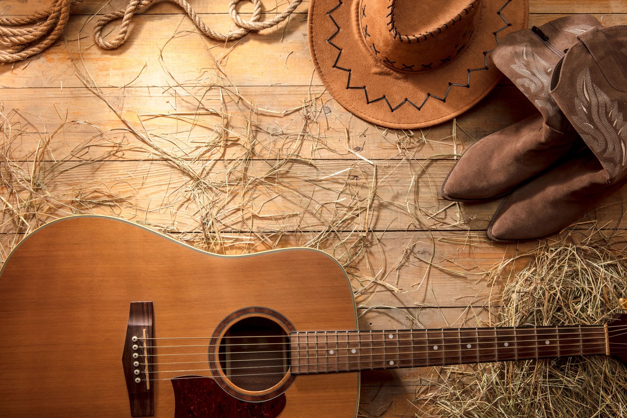Acoustic guitar, cowboy hat, and boots album art